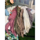 Elegant lace shawl with embroidered stemmed flowers, worn as a small scarf or shrug, from The Bullish Store.