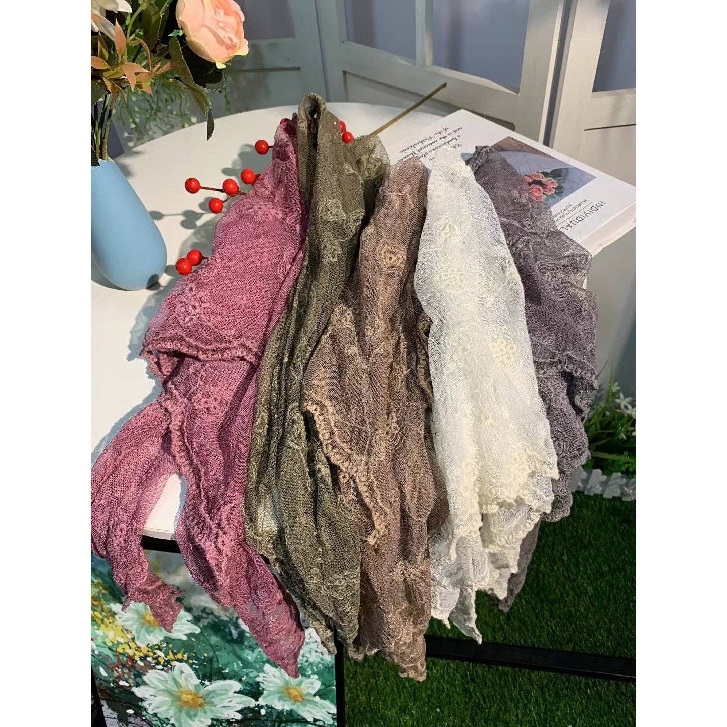 Elegant lace shawl with embroidered stemmed flowers, worn as a small scarf or shrug, from The Bullish Store.
