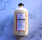 16 oz bottle of The Earthly Alternative fresh citrus laundry and dish detergent concentrate, eco-friendly cleaning solution.