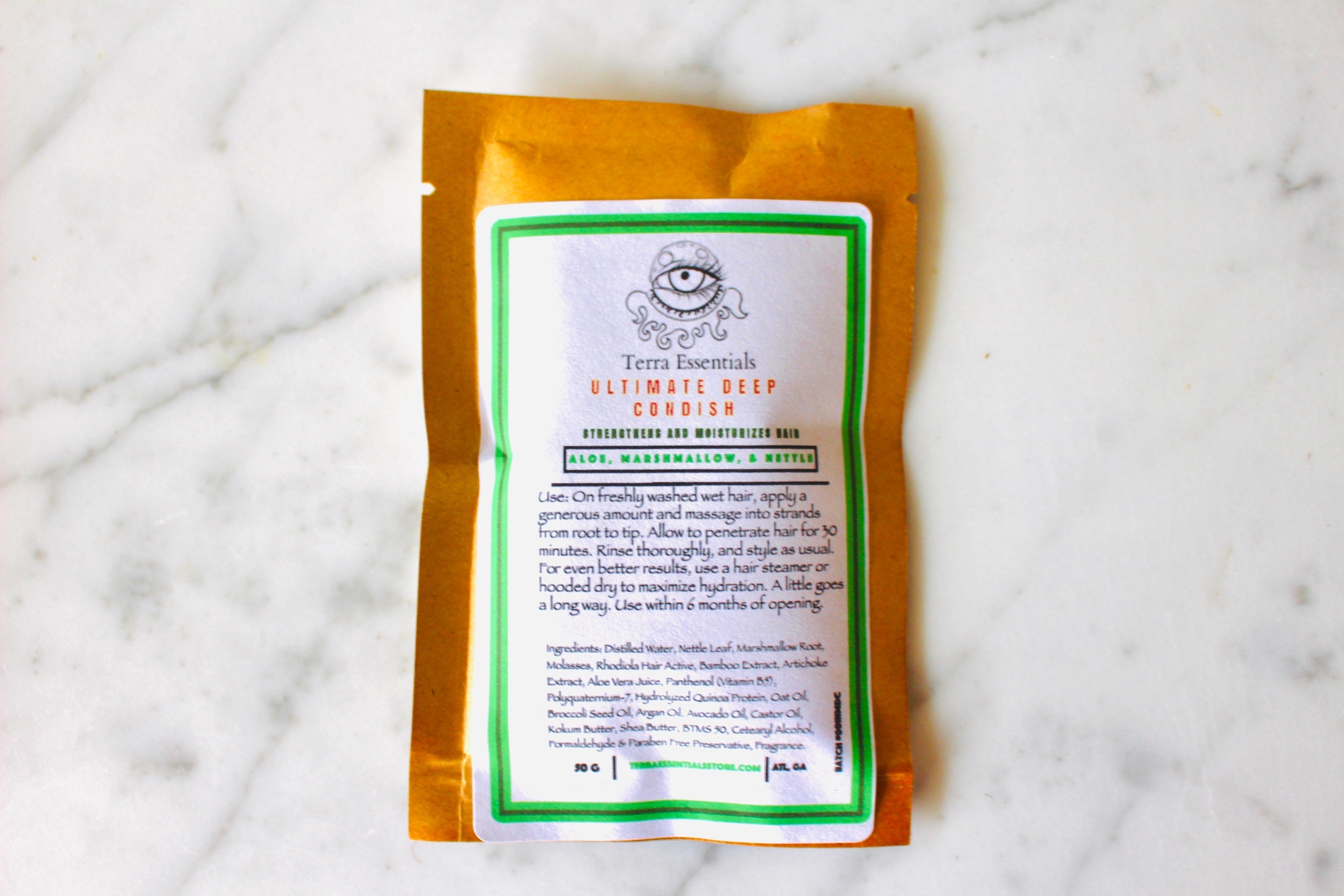 The Earthly Alternative Aloe, Marshmallow, & Nettle Ultimate Deep Conditioner in a 2 oz jar with green and white packaging.