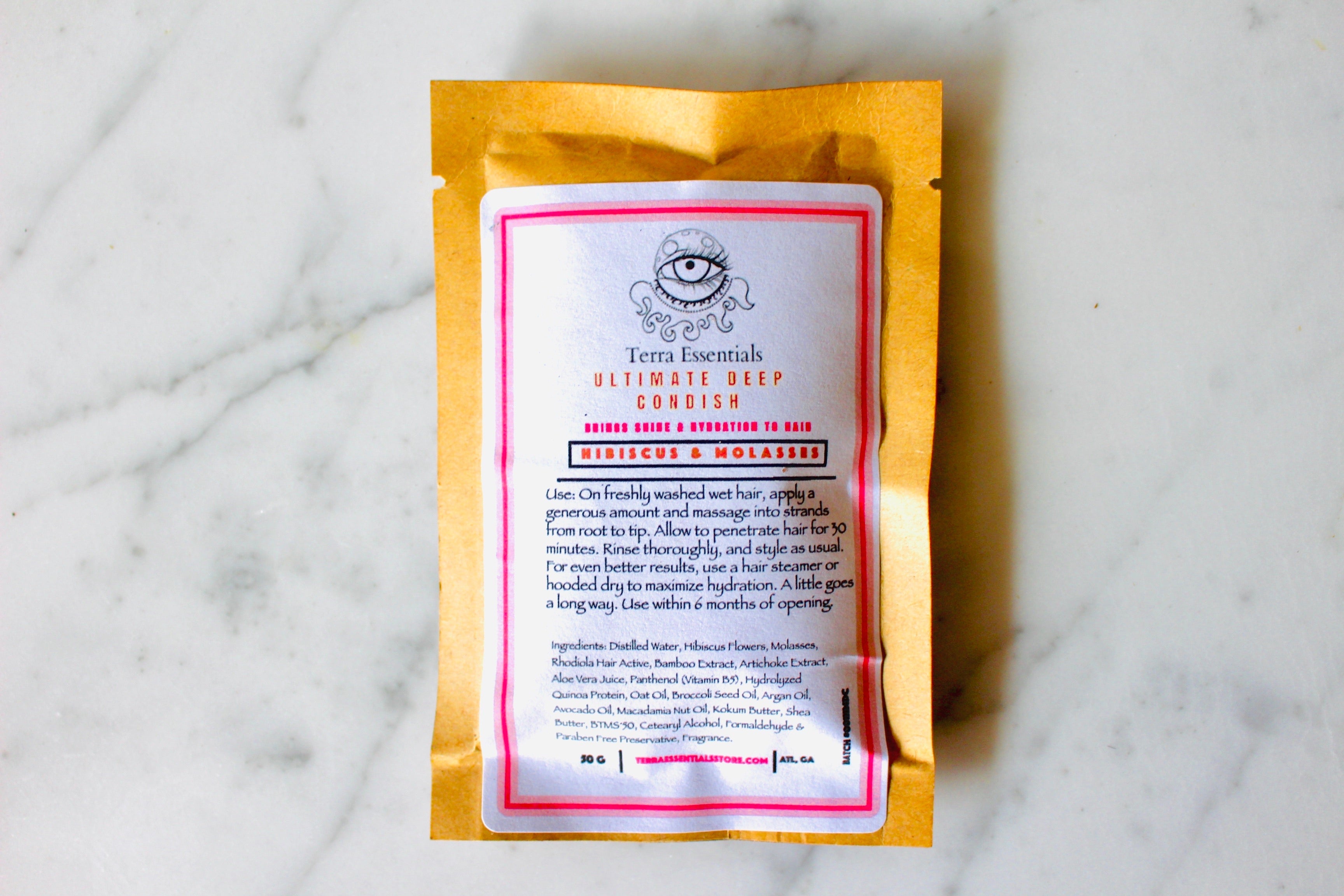 The Earthly Alternative Hibiscus & Molasses Ultimate Deep Conditioner in a 2 oz jar, showing the creamy hair treatment with natural ingredients.