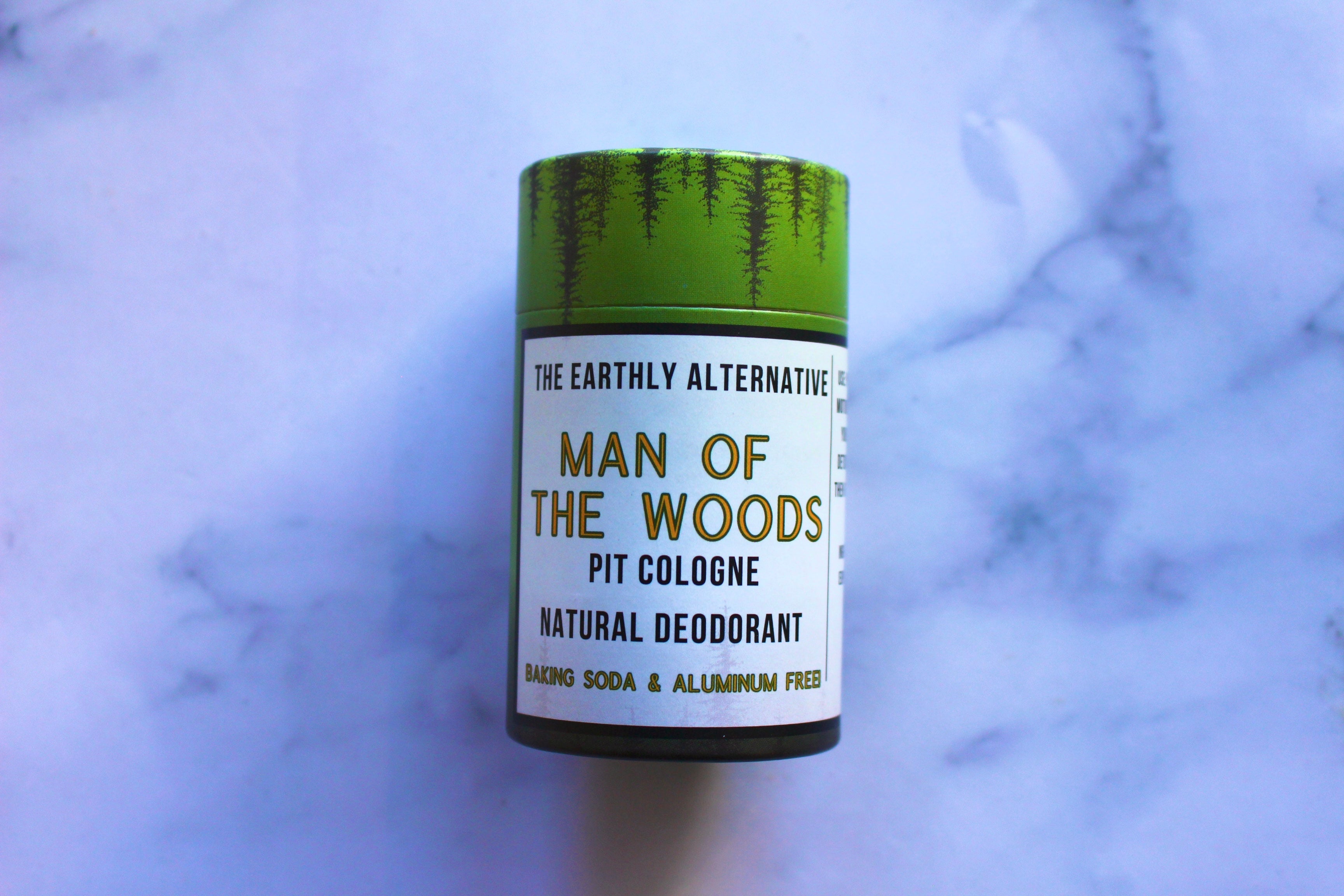 The Earthly Alternative Pit Cologne Deodorant for men, featuring a sleek container with natural ingredients and fresh scent.