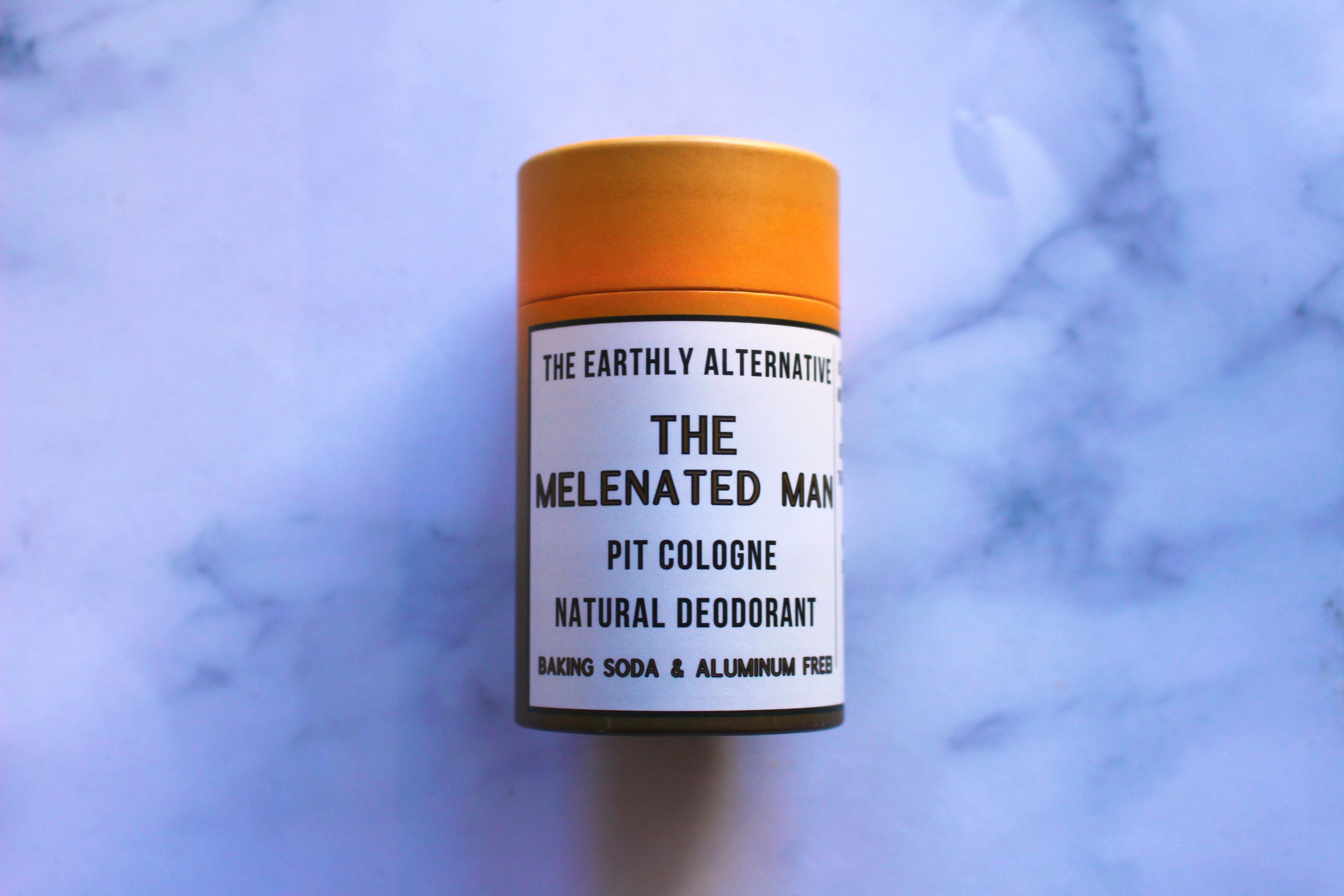 The Earthly Alternative Pit Cologne Deodorant for men, featuring a sleek container and natural scent design.