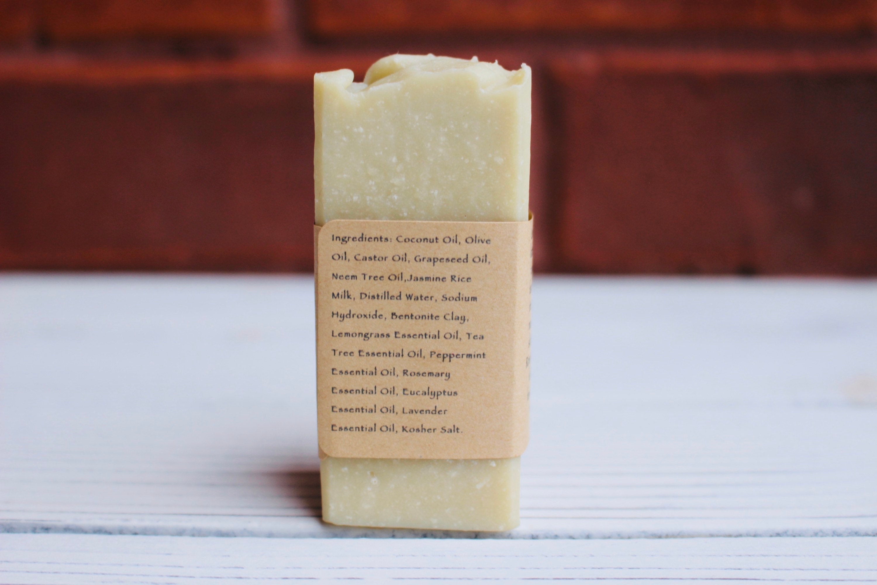 The Earthly Alternative facial bar soap with natural ingredients, showing a rustic, eco-friendly packaging and a textured soap bar.