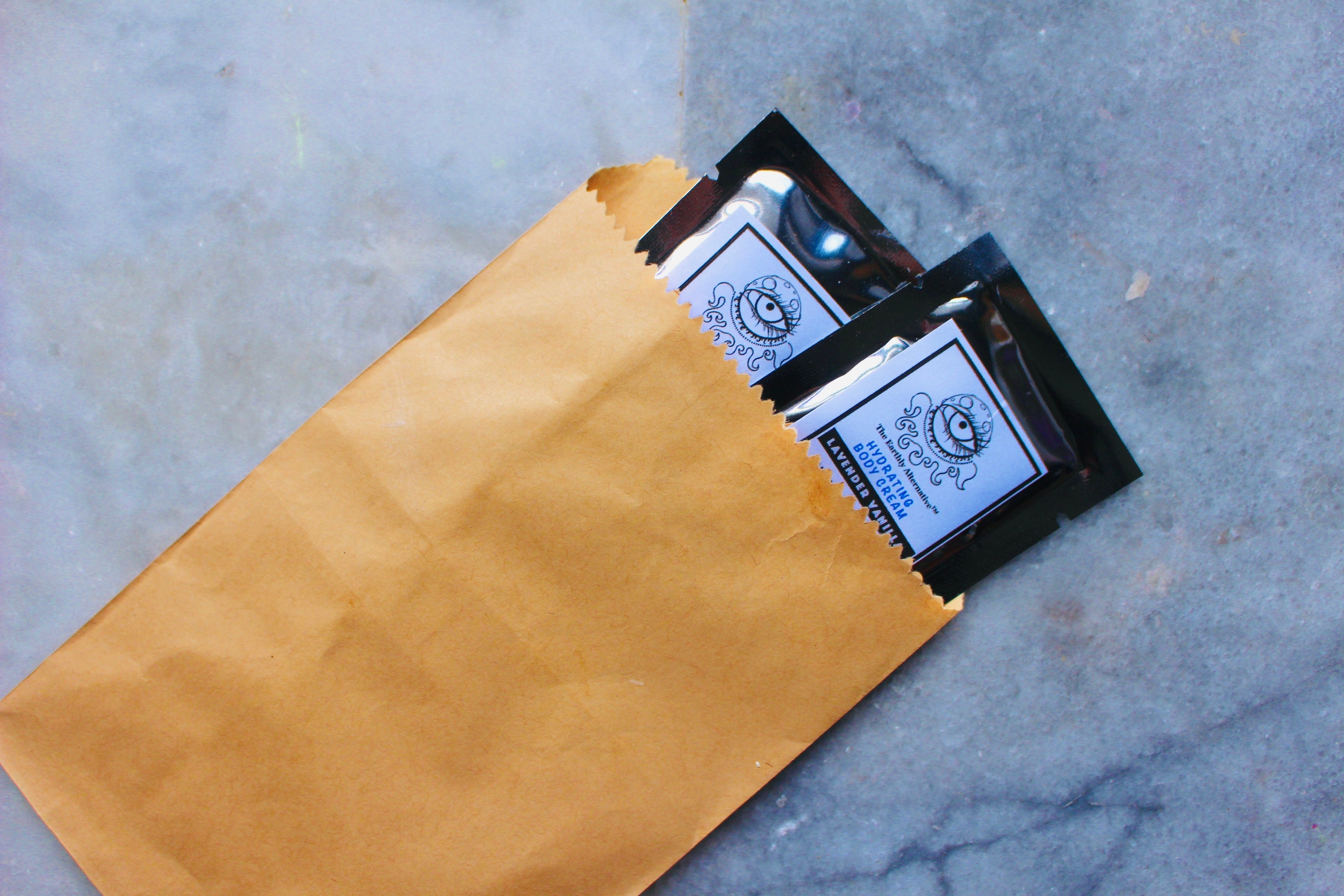Assorted herbal sample pack from The Earthly Alternative, featuring various natural botanical products in individual containers.
