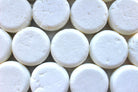 Tingling Tea Tree & Peppermint Shampoo Bar by The Earthly Alternative, showing a natural soap bar with herbal ingredients.