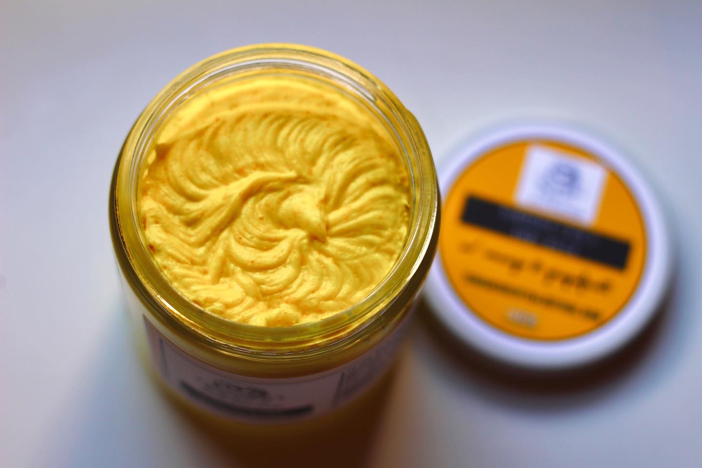 Turmeric Face and Body Wash by The Earthly Alternative, creamy formula with turmeric ingredients, in a pump bottle.