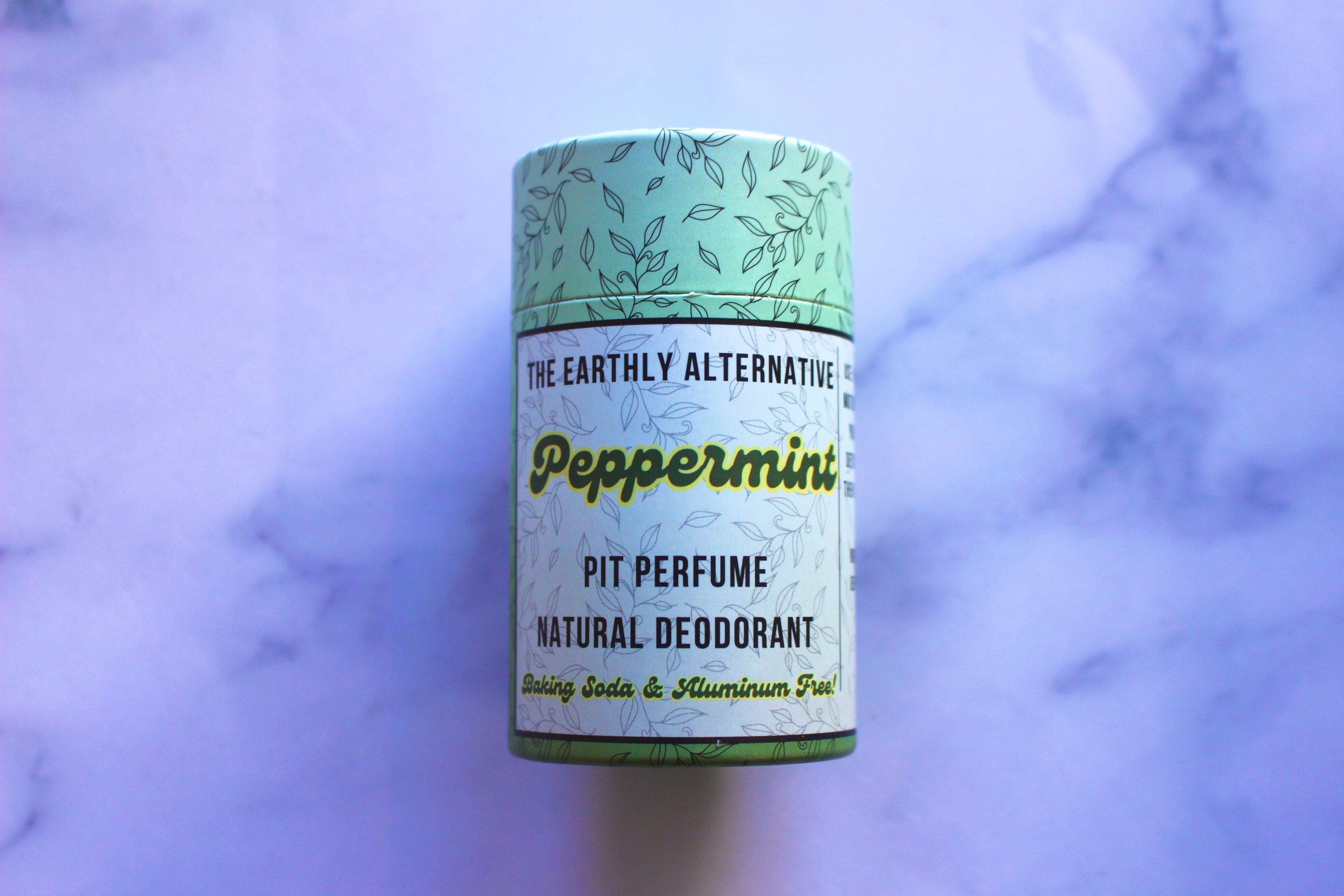 The Earthly Alternative Pit Perfume Deodorant in amber bergamot scent, natural deodorant stick with botanical ingredients.