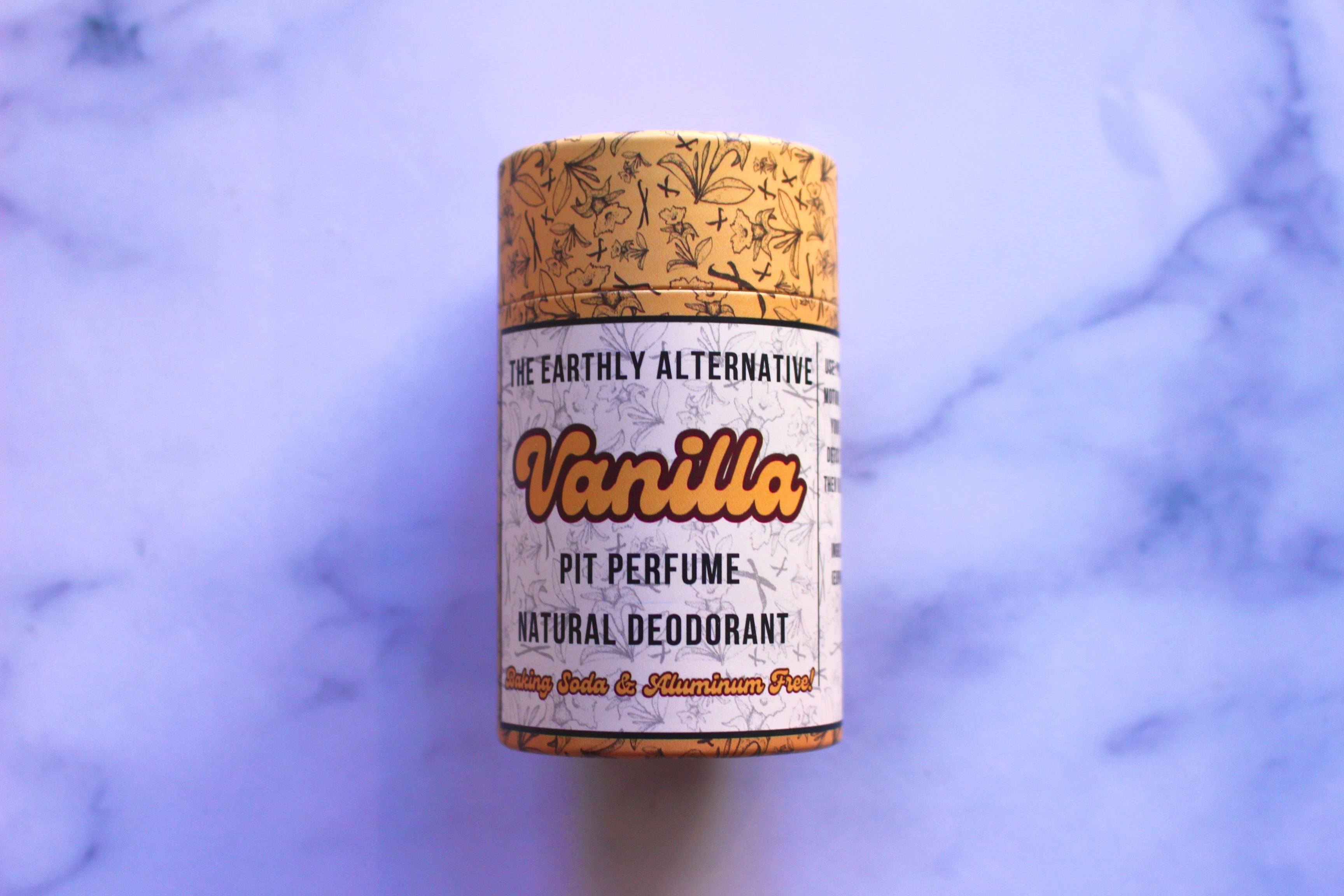 The Earthly Alternative Pit Perfume Deodorant in amber bergamot scent, showing the natural deodorant stick with packaging.