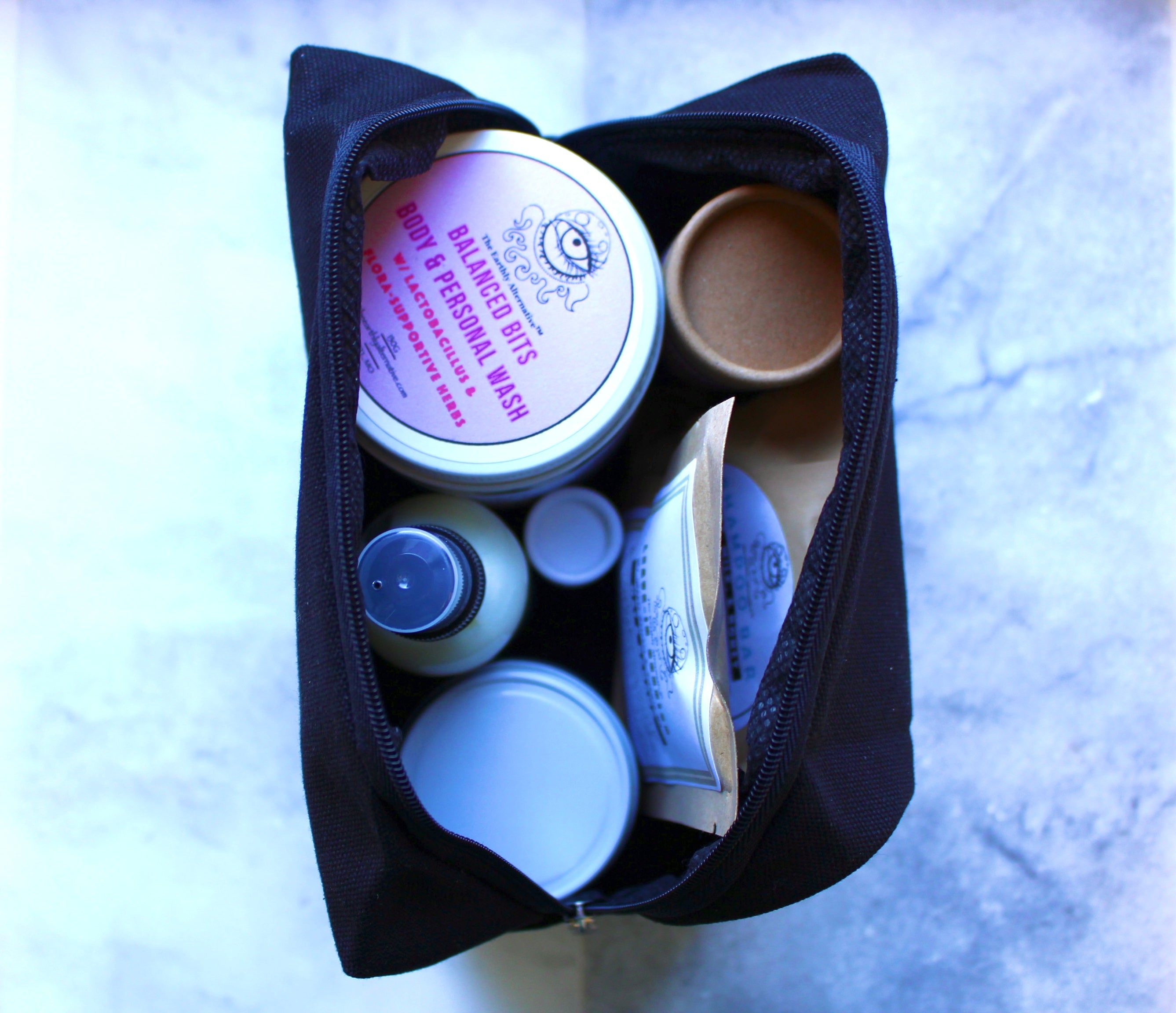 The Earthly Alternative travel pouch with natural deodorant inside, reusable eco-friendly pouch for on-the-go freshness.