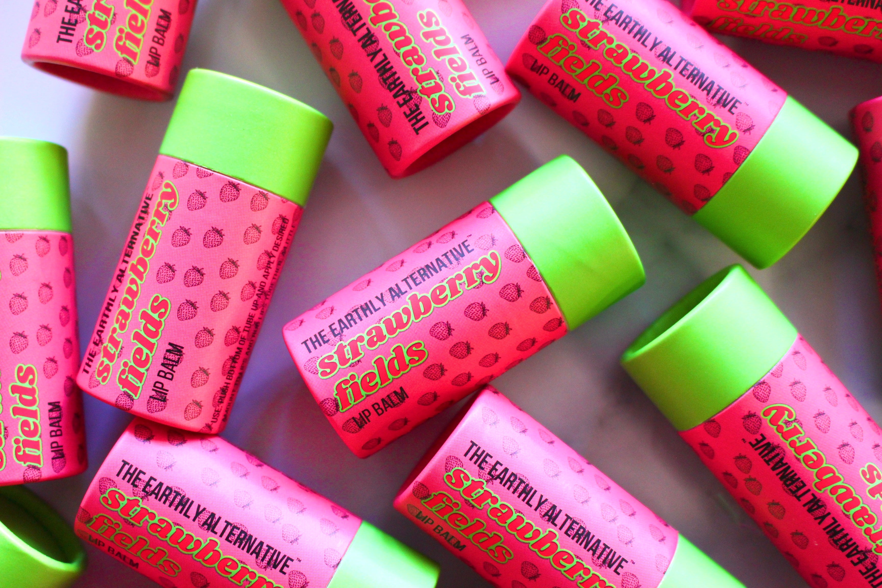 The Earthly Alternative Fluffy Mallow Lip Balm with a smooth, creamy texture in a clear container, designed to moisturize lips.