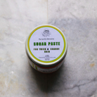 Creamy sugar paste by The Earthly Alternative for hair removal, shown in a close-up of the smooth, pliable waxing product.
