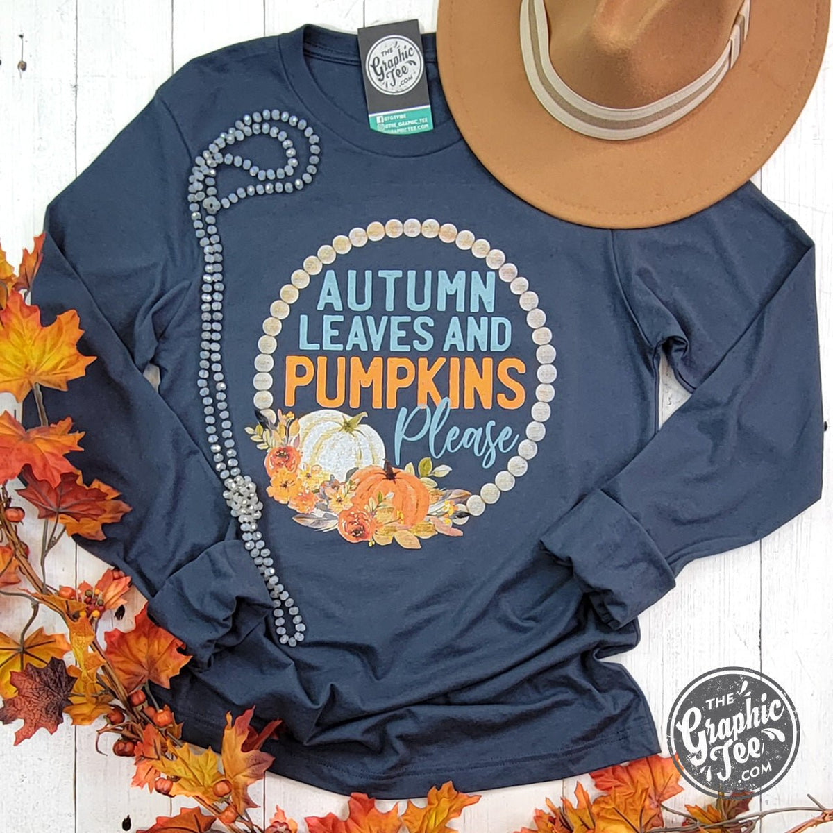 Vintage navy long sleeve tee with autumn leaves and pumpkins graphic, featuring "Please" text, from The Graphic Tee.