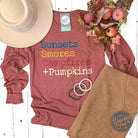 Long sleeve graphic tee by The Graphic Tee featuring sunset, s'mores, campfire, and pumpkin autumn scene design.