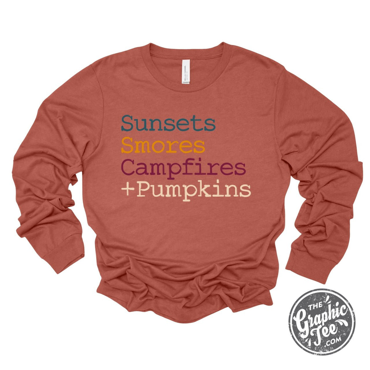 Long sleeve graphic tee from The Graphic Tee featuring sunset, s'mores, campfire, and pumpkin illustrations.