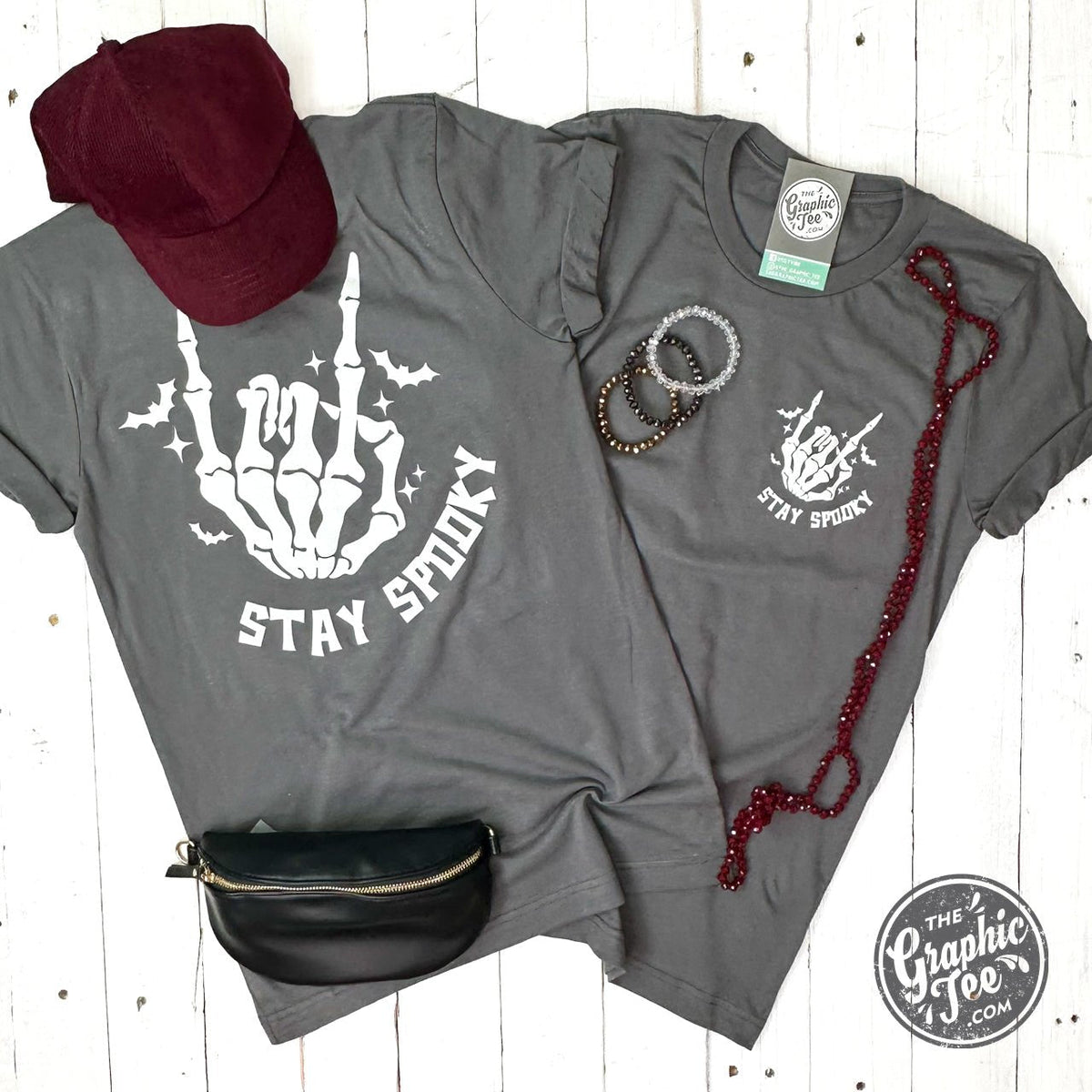 Youth short sleeve graphic tee by The Graphic Tee featuring spooky stay design in black and white.