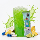 Single Hawaiian Tropics flavored tea from The Loaded Tea Shop in a clear glass with vibrant tropical fruit garnishes.