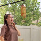 Memorial wind chime from Whispering Hearts™ collection by The Wind Chime Co, 15-inch warm gold with heart-shaped design.