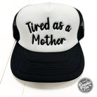 Tired As A Mother foam trucker cap by The Graphic Tee, featuring a casual mesh design and bold printed slogan on the front.
