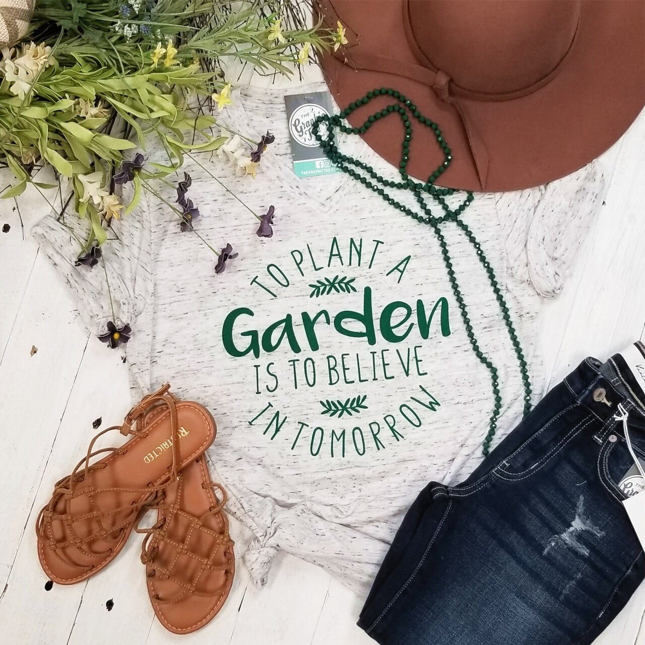 Marble V-neck graphic T-shirt from The Graphic Tee featuring "To Plant A Garden" design, casual short-sleeve style.