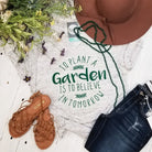 Marble V-neck graphic T-shirt from The Graphic Tee featuring "To Plant A Garden" design, casual short-sleeve style.