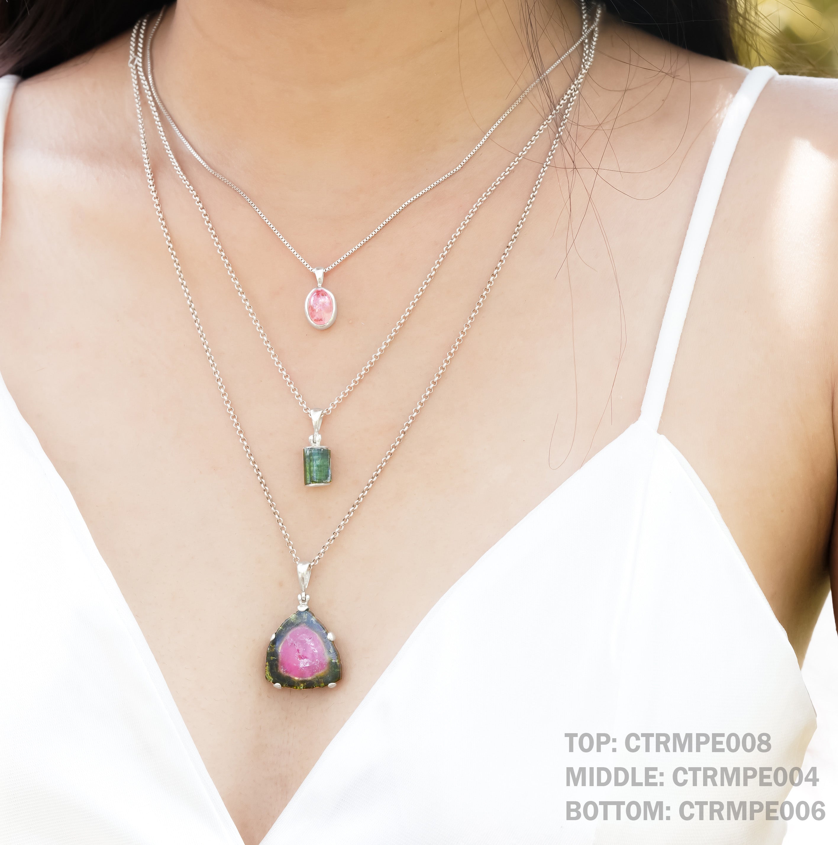 Starborn Creations tourmaline crystal slice pendant in sterling silver, showcasing a vibrant, polished gemstone with a silver bail.