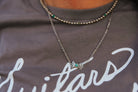 Turquoise butterfly concho chain necklace by Wild Junkie featuring silver-toned conchos and a delicate chain design.