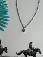 Turquoise heart gold chain necklace by Wild Junkie featuring a delicate gold chain with a turquoise heart pendant.