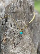Gold chain necklace with a turquoise heart pendant, stylish jewelry piece by Wild Junkie.