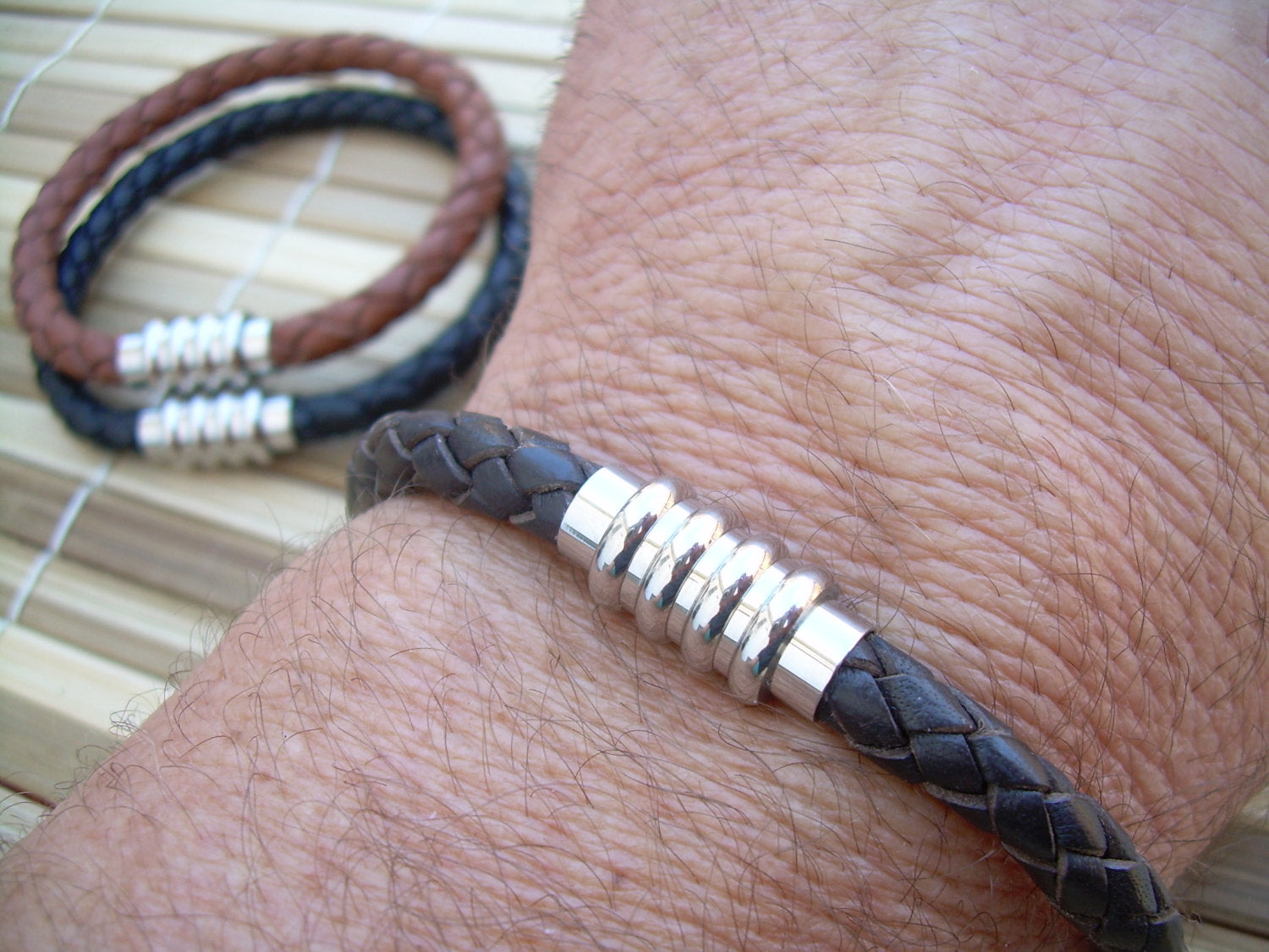 Black men's leather bracelet with stainless steel magnetic clasp, braided design, fits a 6.75-inch wrist.