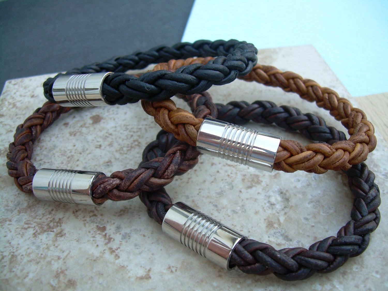 Natural light brown braided leather men's bracelet with stainless steel magnetic clasp, fits a 7-inch wrist, stylish men's accessory.