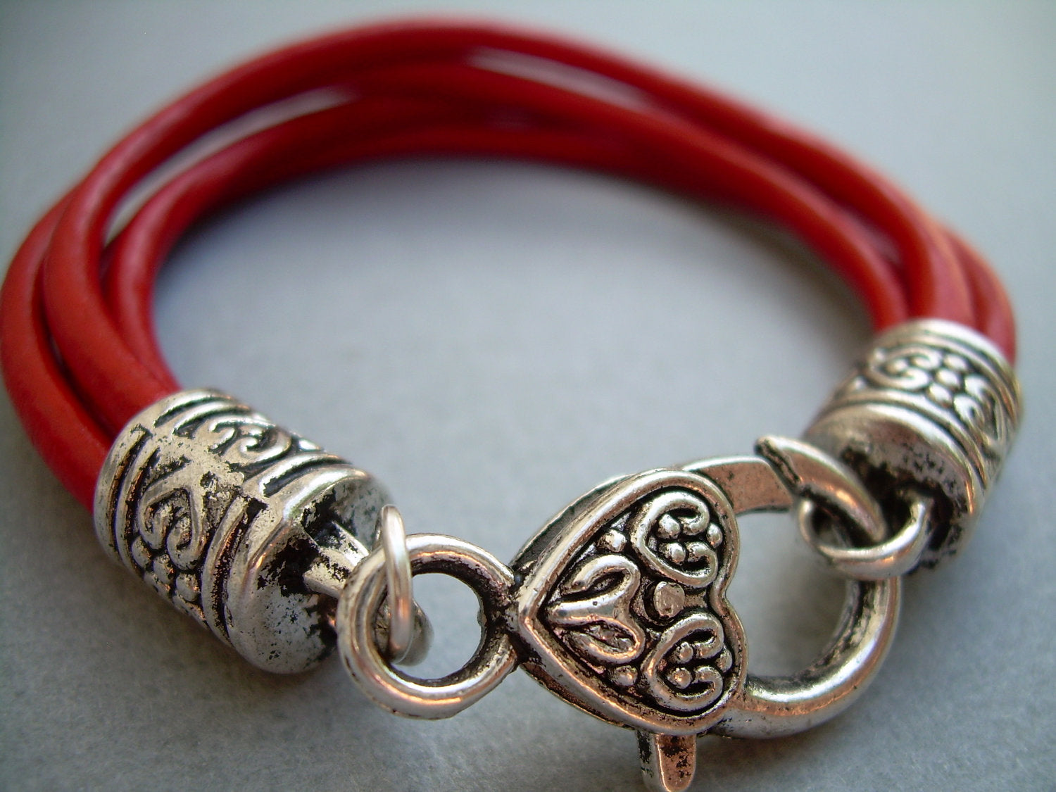 Red leather wristlet bracelet with valet keychain from Urban Survival Gear USA, designed to fit a 6-inch wrist.