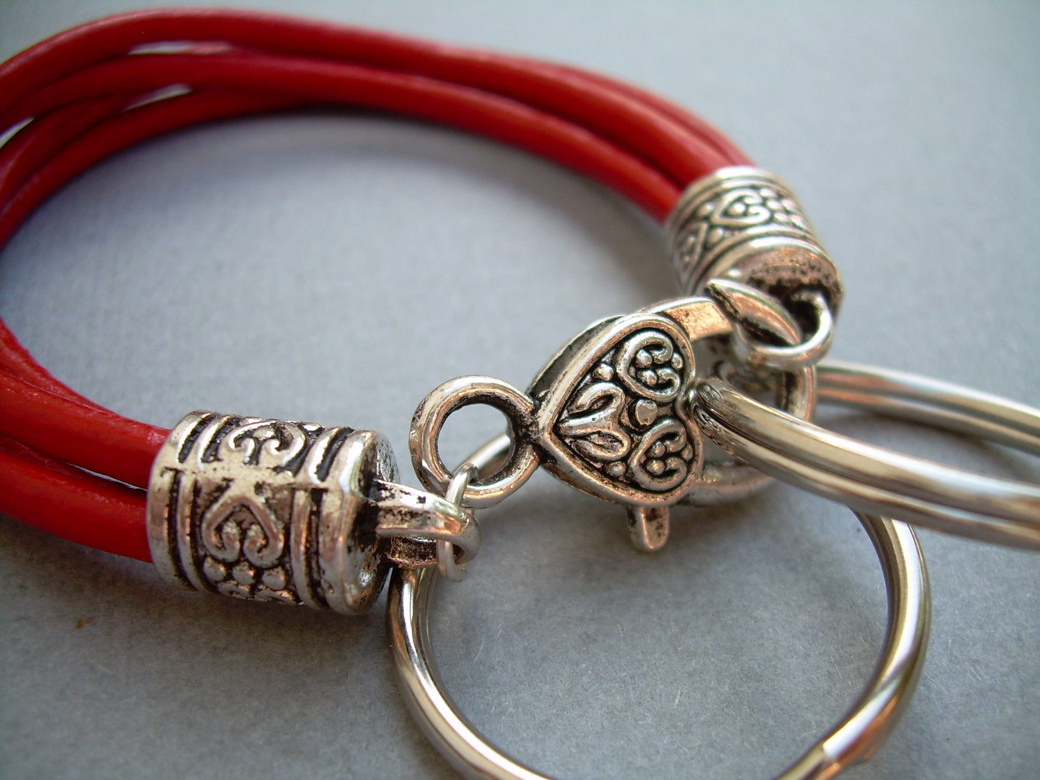 Red leather wristlet bracelet with valet keychain from Urban Survival Gear USA, fits a 6-inch wrist.