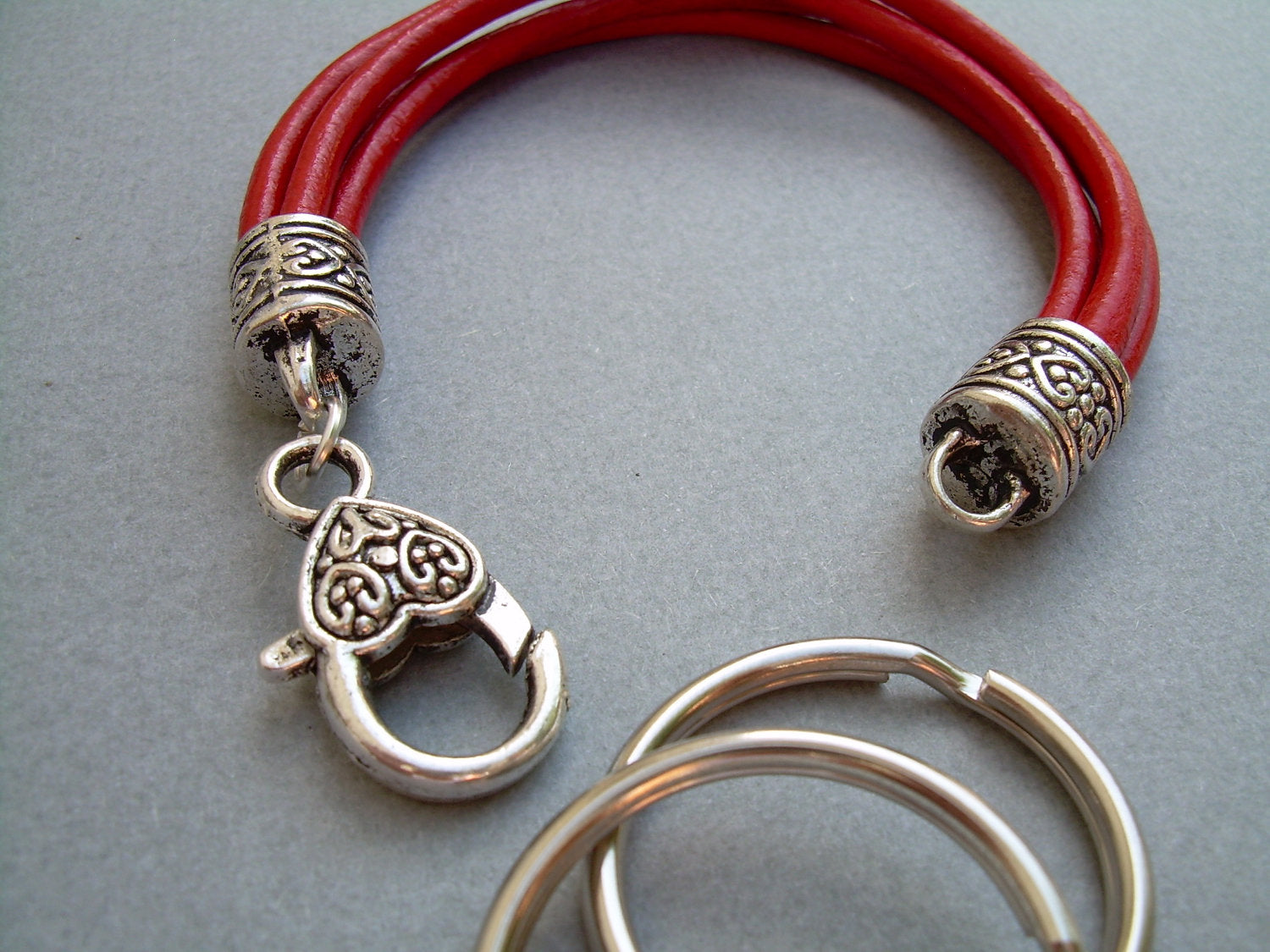 Red leather wristlet bracelet and valet keychain by Urban Survival Gear USA, fits a 6-inch wrist, stylish and functional accessory.