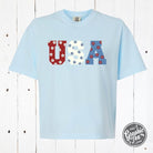 USA 90's inspired floral graphic mid-length pigment dyed tee by The Graphic Tee, showing vibrant floral design on soft fabric.