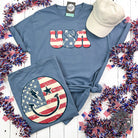 USA Smiley Face Comfort Wash Short Sleeve Tee by The Graphic Tee, featuring a cheerful smiley face graphic on a casual short sleeve T-shirt.