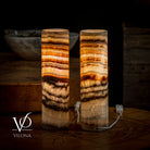 Pair of Vilona Onyx Sahara Onyx desk lamps featuring cylindrical design and warm-toned onyx bases on a table.