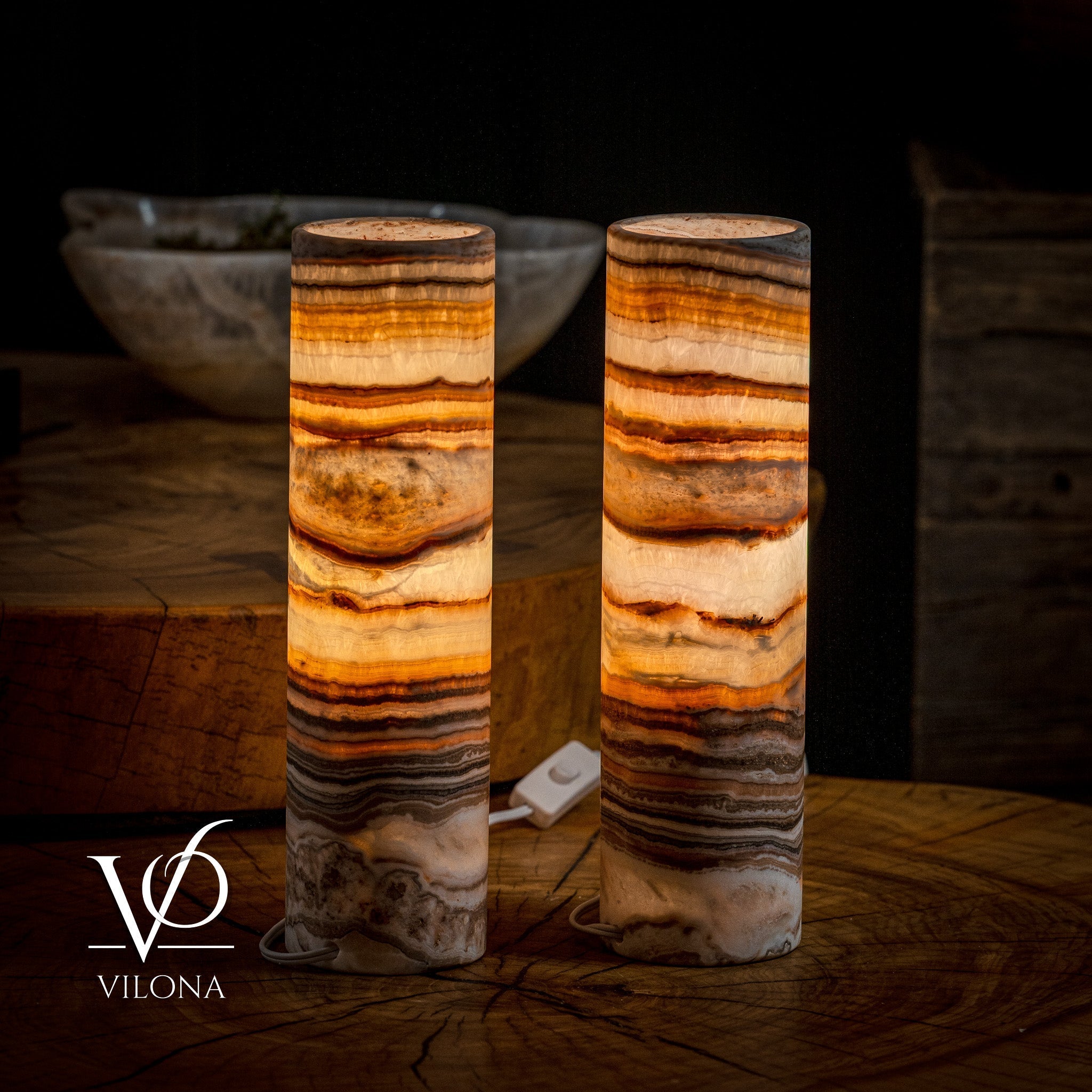 Pair of Sahara Onyx cylinder desk lamps by Vilona Onyx, showcasing sleek black and gold-toned table lamps with modern design.