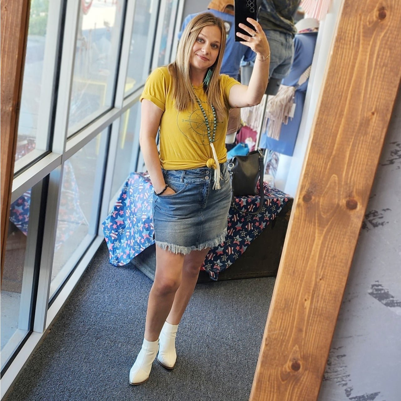 The Graphic Tee Wanderlust SS Graphic Tee featuring a colorful travel-inspired design on a casual t-shirt.