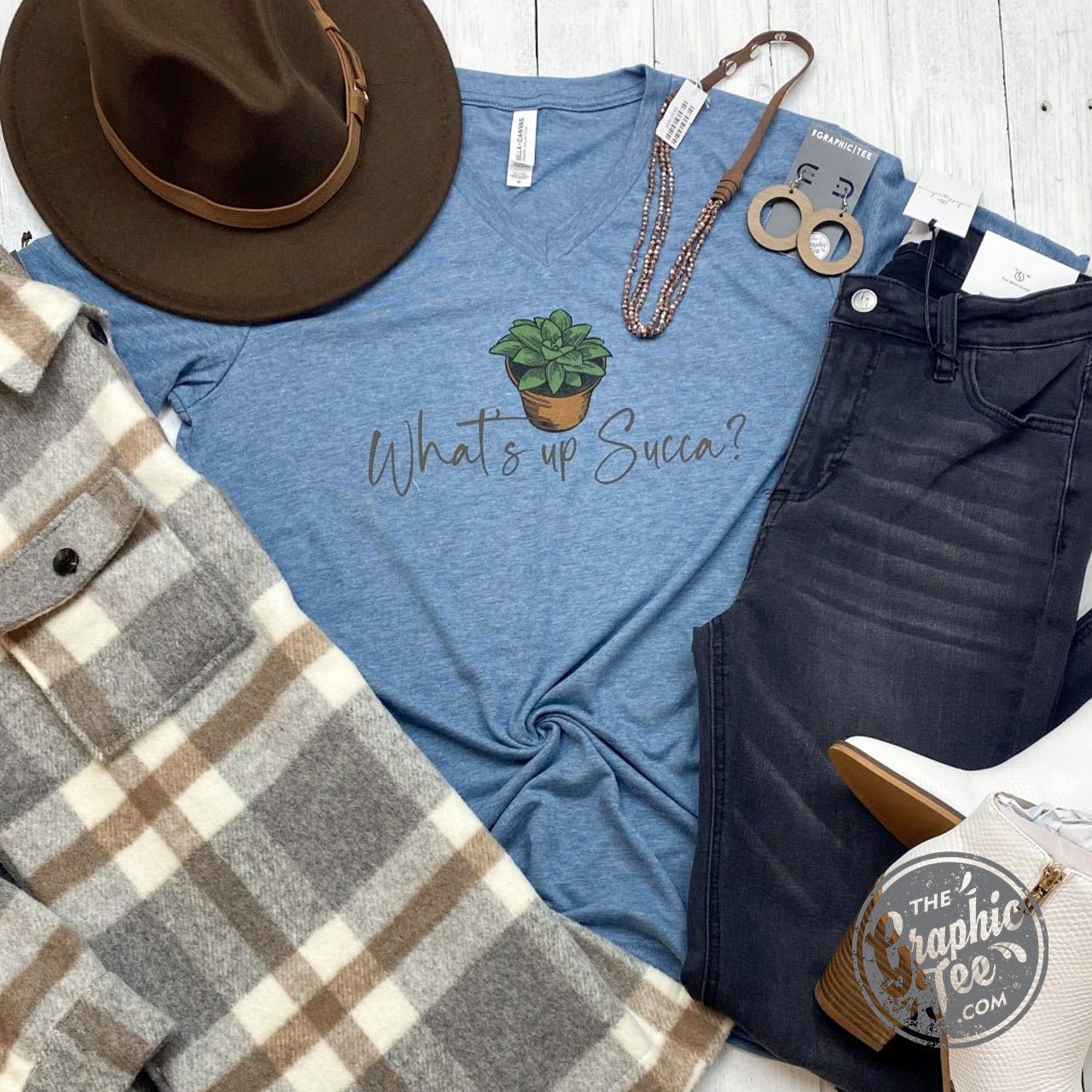 The Graphic Tee What's Up Succa? V Neck Tee, short sleeve graphic t-shirt with a vibrant design on a casual V-neck style.