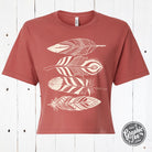 Wild Feathers waist-length crop tee by The Graphic Tee featuring a vibrant feather graphic on a casual SS graphic tee.