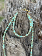 Golden turquoise trail heishi beaded bracelet by Wild Junkie featuring small round beads on a stretchy cord.