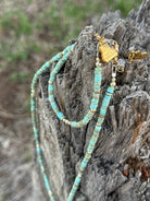 Golden turquoise trail heishi beaded bracelet from Wild Junkie featuring small round beads on a stretch cord.