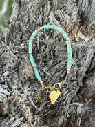 Golden turquoise heishi beaded bracelet by Wild Junkie, featuring a stylish trail design with colorful small beads.