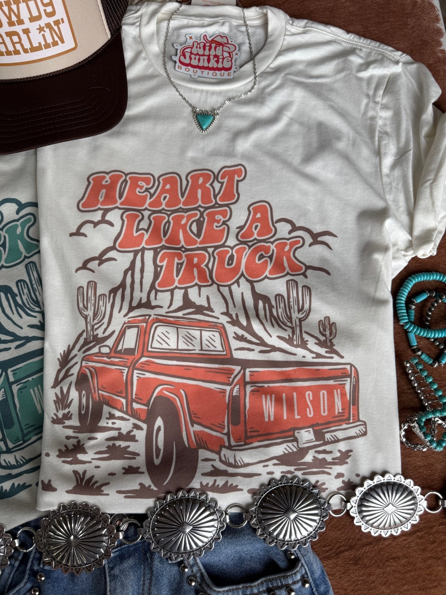 Coral Heart Like A Truck graphic tee by Wild Junkie featuring a truck-shaped heart design on soft cotton fabric.