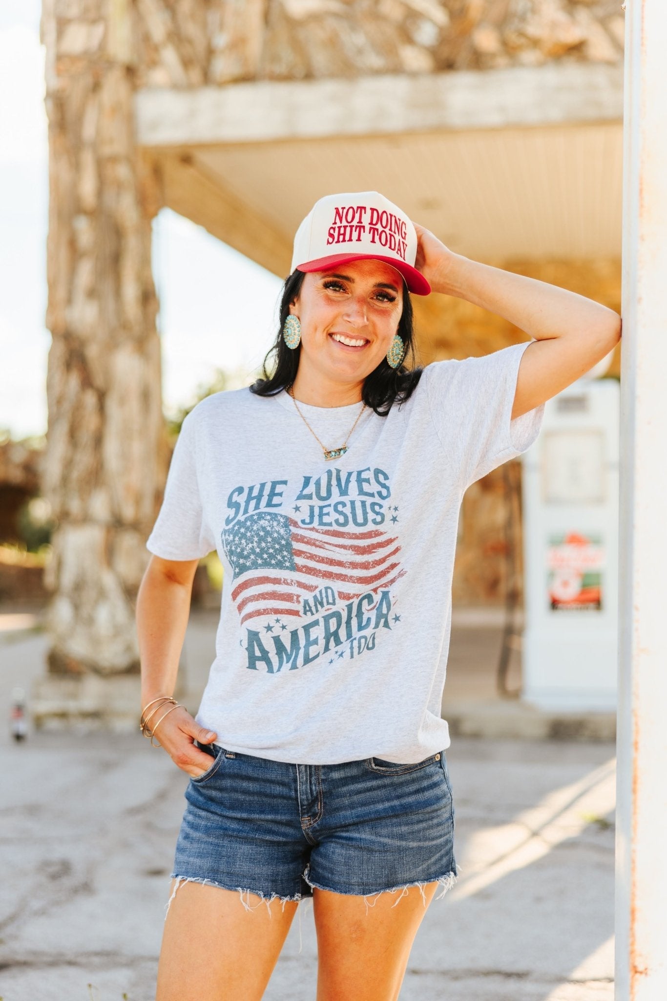 Wild Junkie She Loves Jesus & America graphic tee, white cotton T-shirt with patriotic and faith-themed design for women.