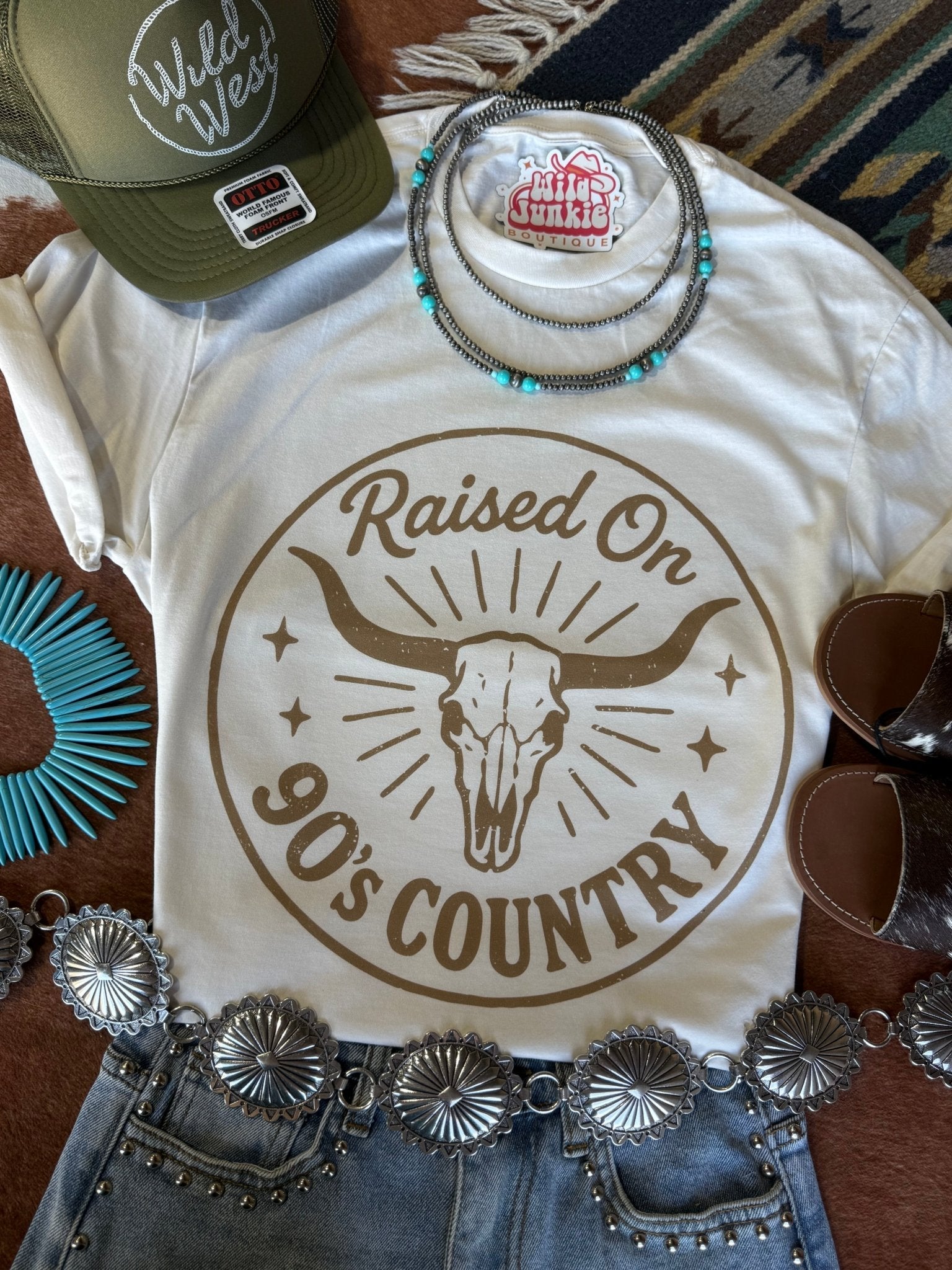 Wild Junkie raised on 90's country steer skull graphic t-shirt showing a vintage style design on soft cotton fabric.