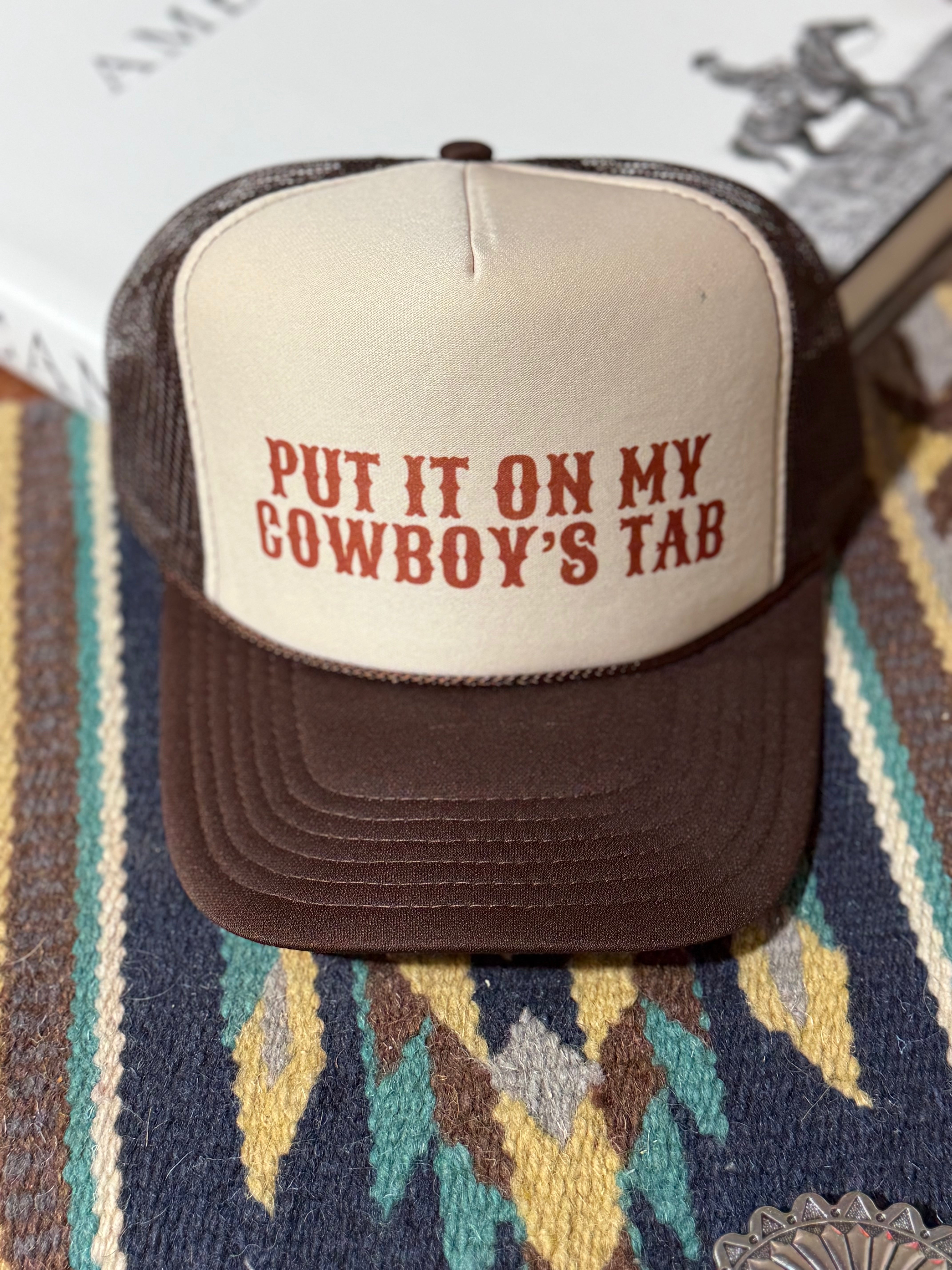 Wild Junkie cowboy trucker hat with "Put It On My Cowboy's Tab" embroidered design, casual outdoor headwear for men.