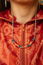 Authentic Spiny Oyster Chip Bead Necklace featuring vibrant orange and red beads, handcrafted by Wild Junkie for a boho look.