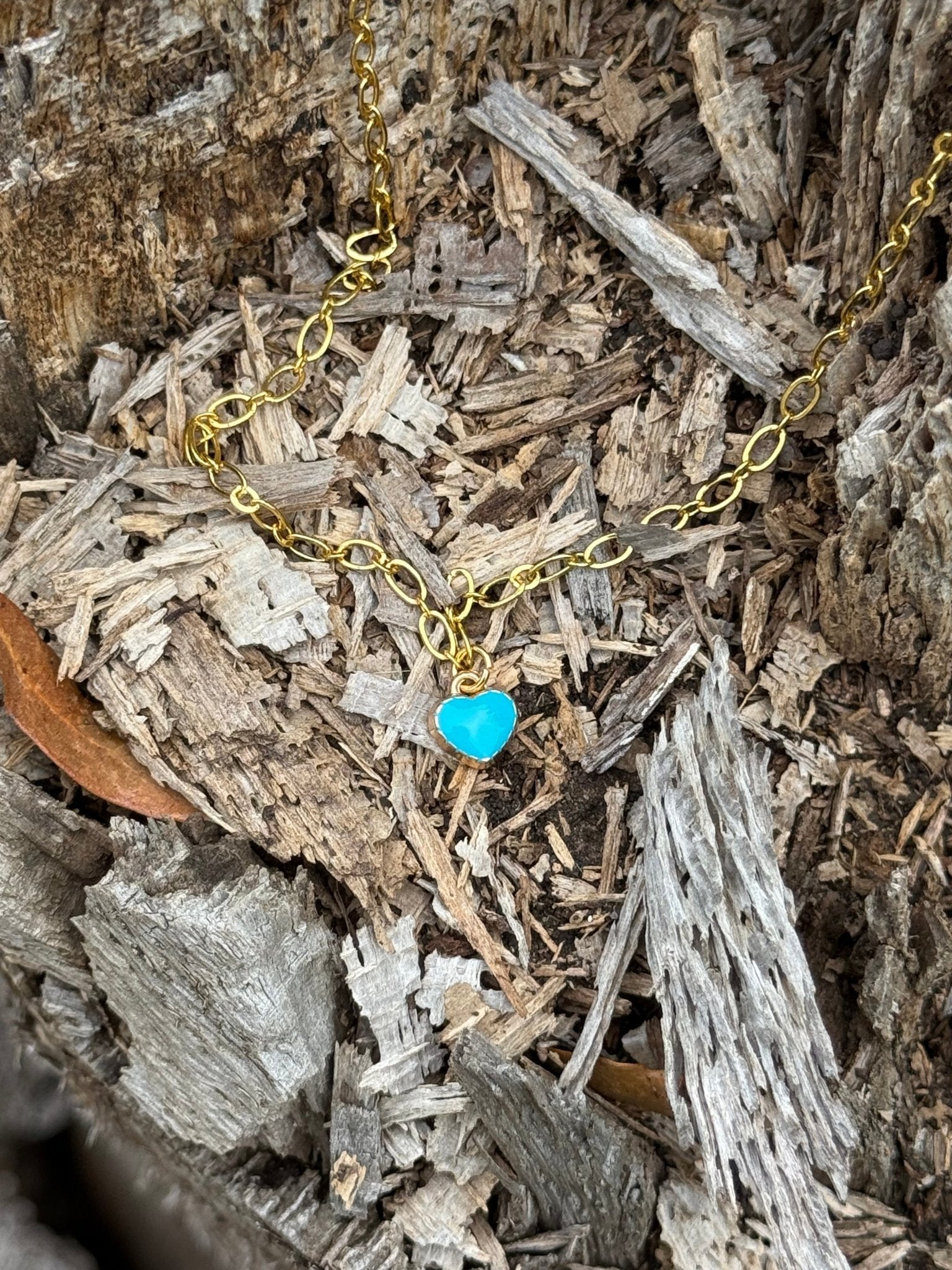 Turquoise heart gold chain necklace by Wild Junkie featuring a delicate gold chain with a turquoise heart pendant.